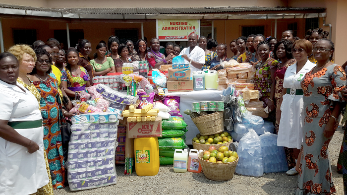 Mr Emmanuel Pappoe receiving the items from Ms Comfort Ofori Angmor, the President of the NVTI Ladies Club